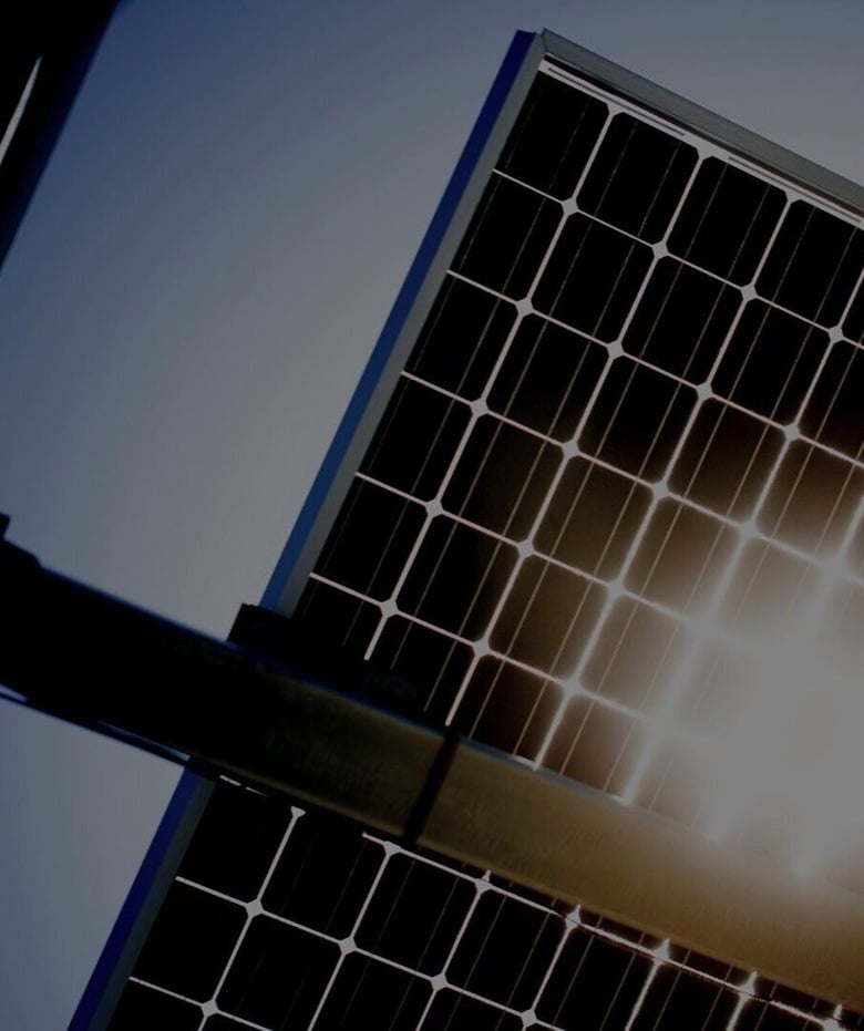 Photo of Solar Panels Backlit by Sun.